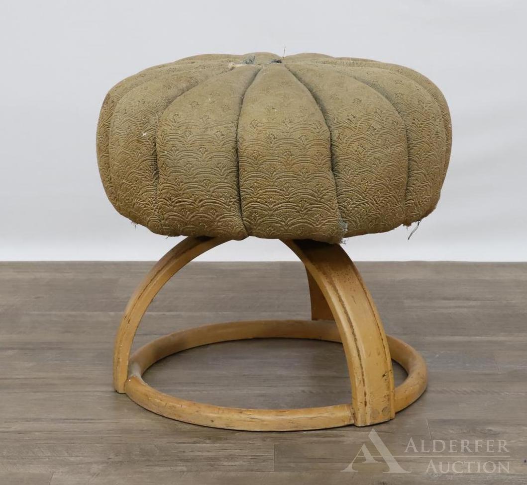 Heywood Wakefield Pouffe: Upholstered pouf with curved birch wood legs on circular base. Illegible label on underside. Upholstered is damaged. 18"h x 18" round