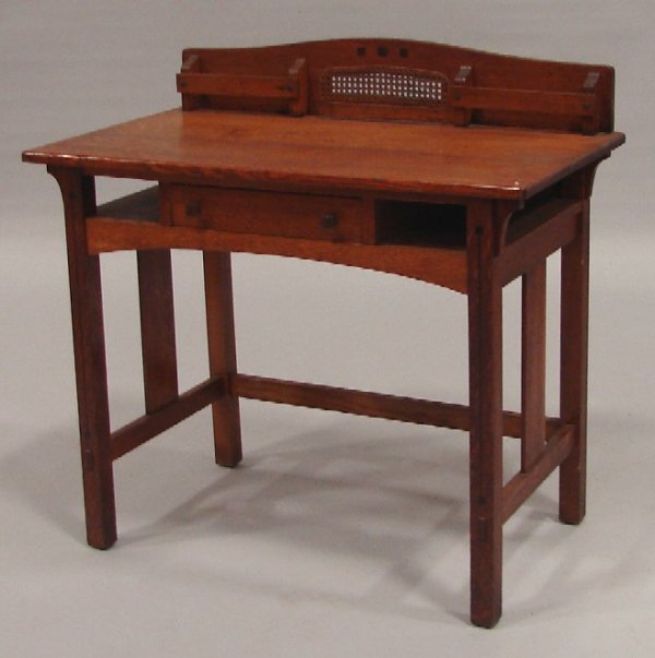 Limbert Writing Desk: Oak arts and crafts inlaid writing desk, backsplash with letter holders, cane inset, single drawer, branded inside drawer, 29 1/2"t., 36"w., 20"d. Shipping: Call for quote. Estimate: $500-700