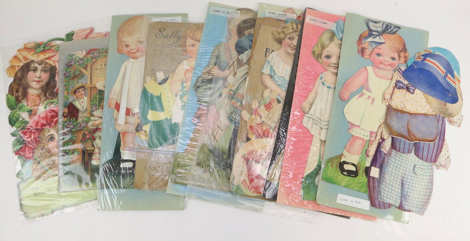 LOT OF HOLIDAY/NOVELTY.: Lot of large paper dolls and advertising ephemera. Paper dolls - measure approximately 19" T. There are (7) cardboard dolls with additional clothing. "Sally" is dated 1931 and was published by Saalfie
