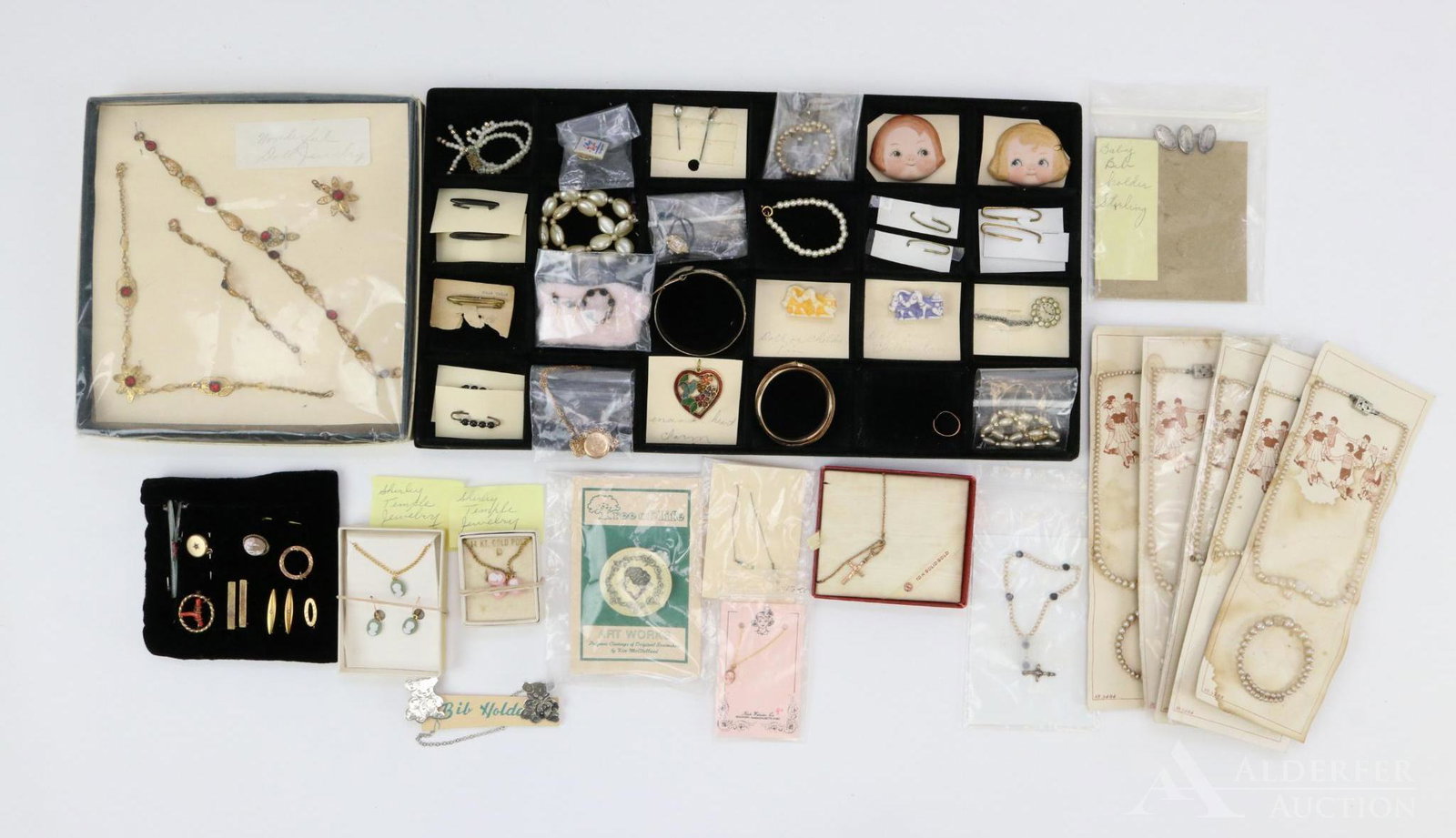 LOT OF ANTIQUE/VINTAGE ACCESSORIES.: Lot of antique/vintage jewelry for dolls and children. Children - (5) Carded pearl necklace/bracelet sets. Baby bracelets. 10K Gold cross necklace, ring, Shirley Temple cameo necklaces/earrings. Bib h