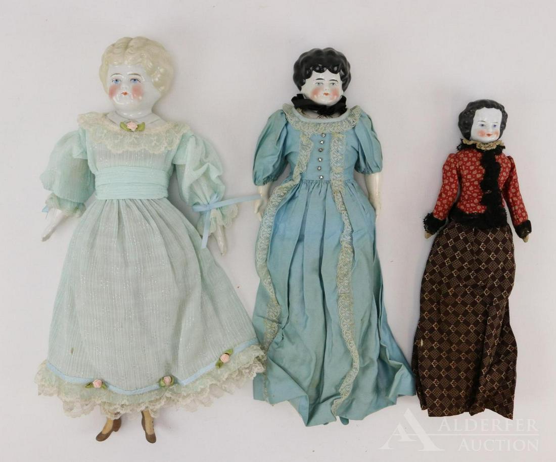 LOT OF CHINA/PARIAN DOLL(S).: Lot of (3) china shoulder head dolls. Pair of Low brow "Pet Name" dolls. 16" Doll has black hair and a molded bodice with name "Marion". She is marked: PATENT APPD FOR GERMANY. Vintage cloth body with