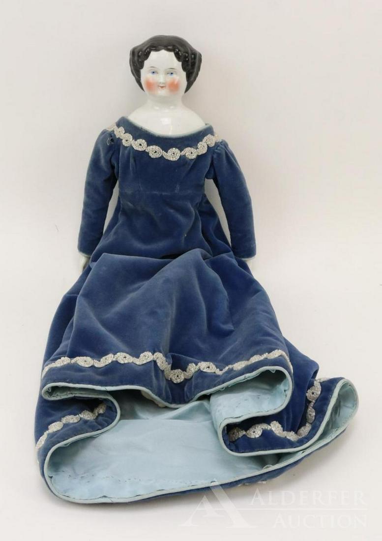LOT OF CHINA/PARIAN DOLL(S).: 19" Unmarked 1870's-1880's china shoulder head doll with black center part hair, blue eyes. Very rosey cheek coloring. Cloth body with china lower arms, legs with pink boots. Dressed in vintage velvet