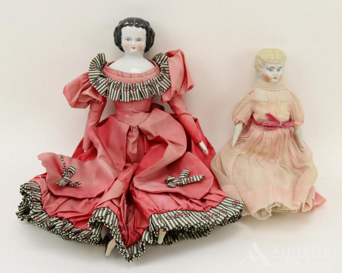 LOT OF CHINA/PARIAN DOLL(S).: Pair of dolls. China - 18" unmarked 1870's-1880's shoulder head doll with black center part hair, blue eyes. Vintage cloth body, china lower limbs with painted black flat soled boots. Dressed in vinta