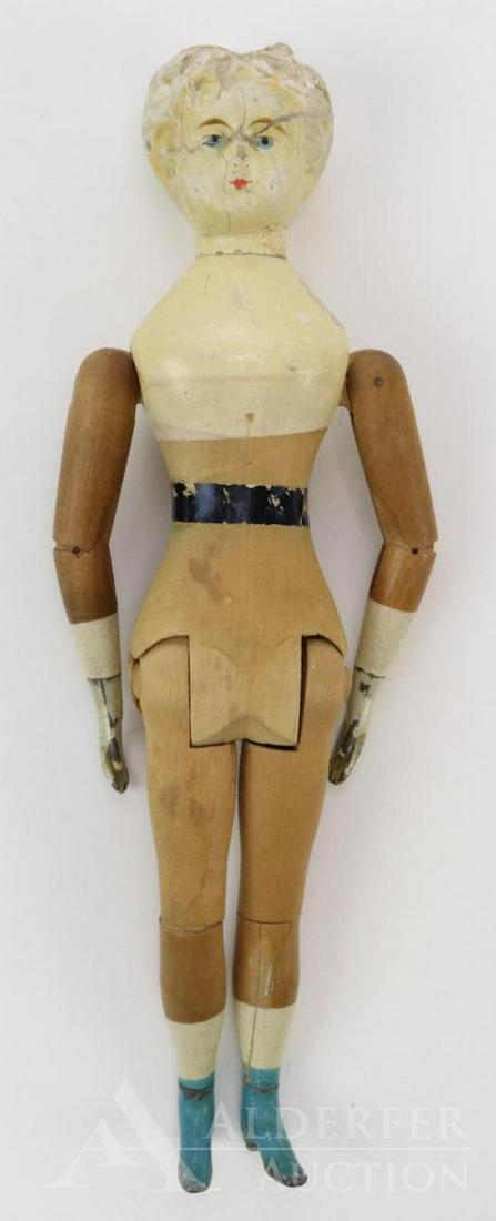 JOEL ELLIS DOLL.: 12" All wood doll with mortise and tendon joints, carved blonde hair, painted features. Metal hands and feet with painted turquoise boots. Black paper band around waist. NO clothing. Condition: paint 