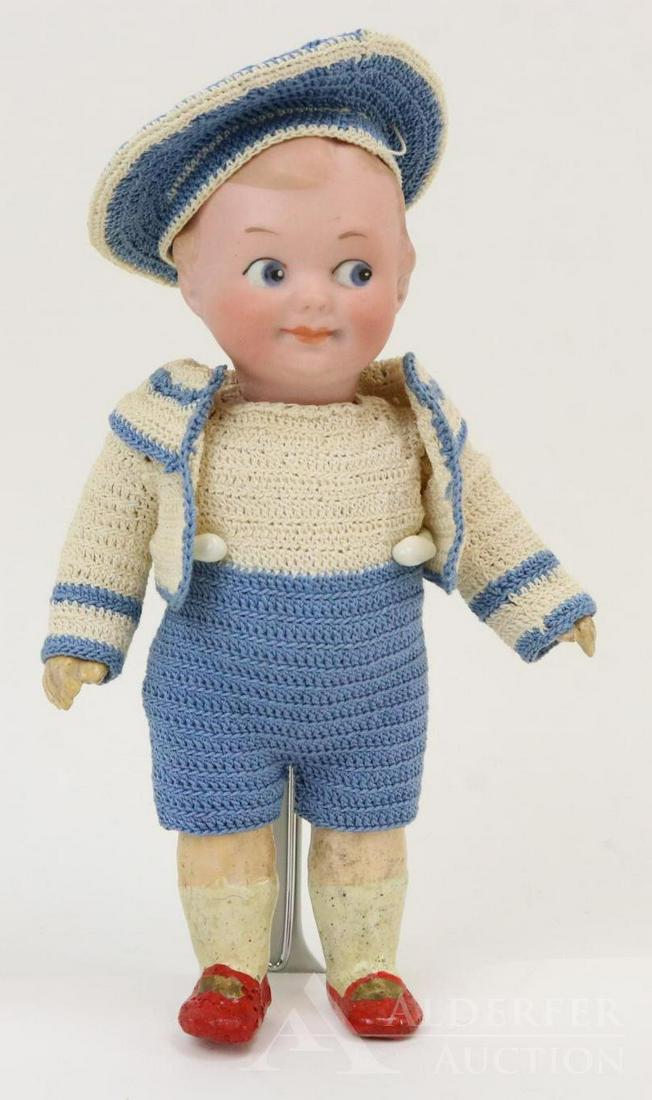 GERMAN BISQUE DOLLS, UNDER 12".: 6 1/2" 322.A.11/0.M. Solid dome Googly eye doll. Blue integlio side glance eyes, watermelon smile, painted light brown hair. 5 Pc. papier mache body with painted red shoes. Dressed in 3 pc. crocheted