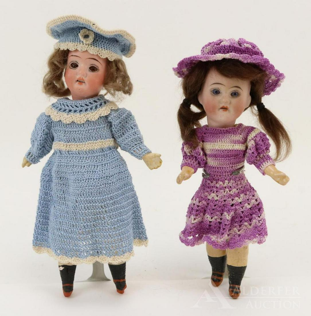 GERMAN BISQUE DOLLS, UNDER 12".: Pair of dolls. Both dolls have open mouths, mohair wigs, 5 pc. papier mache bodies with painted rust shoes, black socks. They are each wearing a 3 pc. crocheted outfit. 2-Strap shoes. (2) Stands. 7 1/