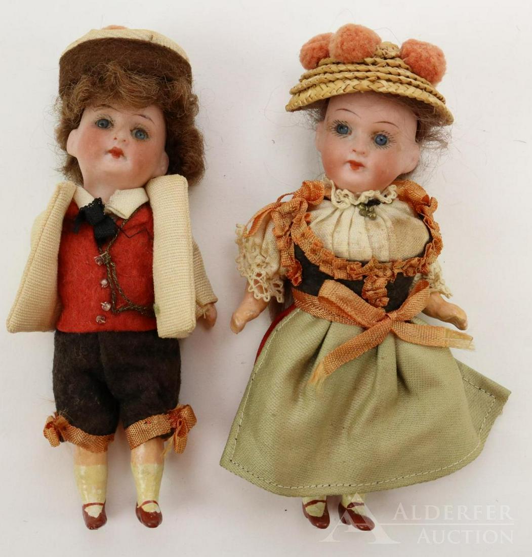 GERMAN BISQUE DOLLS, UNDER 12".: Pair of dolls. Pair of 4 1/2" dolls marked GERMANY A.16/0.M. All original companion dolls have stationary blue eyes, closed mouths, brown mohair wigs, 5 pc. papier mache bodies with painted rust 1-str