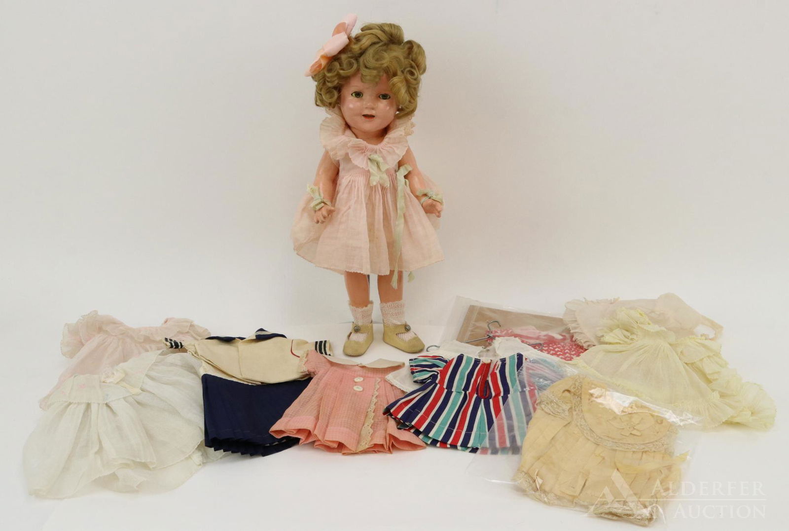 LOT OF COMPOSITION DOLL(S).: 13" Ideal Shirley Temple doll in original dress, underwear, ivory oilcloth shoes. Comes with wardrobe of the period. Condition: sleep eyes still have good color. Wig has been restyled but full. Pleati