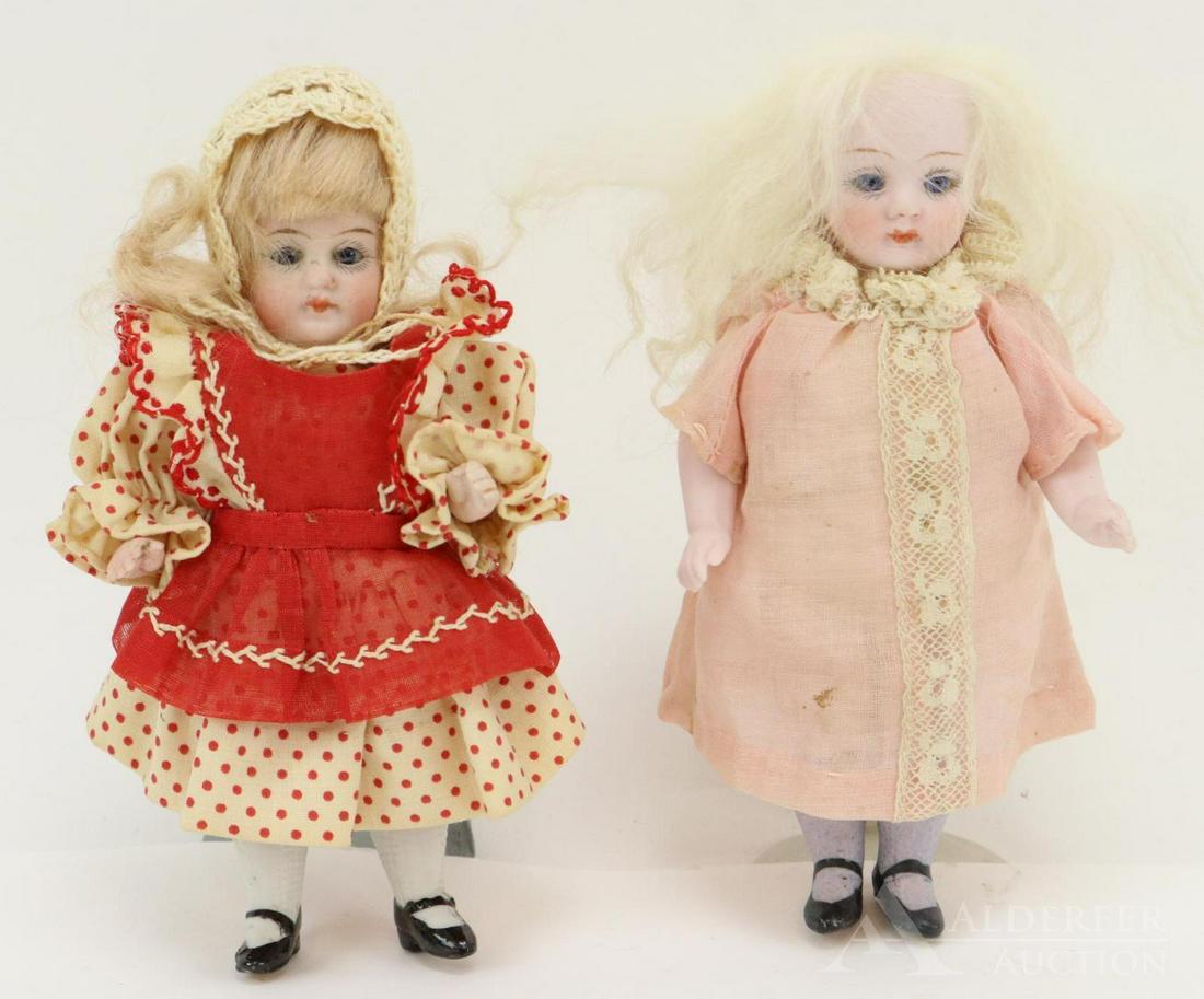 LOT OF ALL BISQUE DOLL(S).: Pair of 5" dolls with stationary eyes, closed mouths. 5 Pc. bodies with black shoes, shirred stockings. Doll 1) 540/3 has blue eyes, long white fur wig. Blue stockings. Antique dress, underwear. Condi