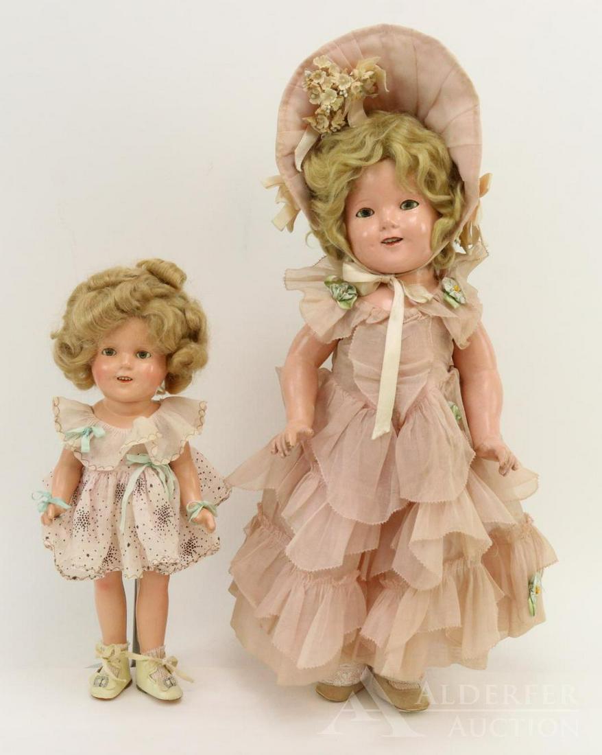 COMPOSITION DOLL LOT.: Pair of Ideal "Shirley Temple" dolls. 13" Doll is dressed in an original unmarked cotton print dress, ivory oilcloth shoes. Replaced taffeta panties, no petticoat. Good eye color. Hair has been played