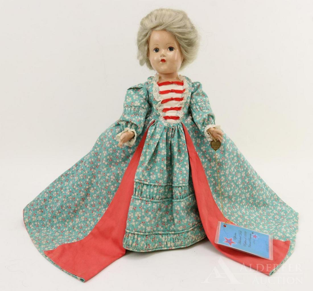 COMPOSITION EFFANBEE HISTORICAL DOLL.: 14" 1939 All original "1720 The Pioneer American Spirit" doll. Painted blue eyes, gray human hair wig. Elaborate floral cotton print gown with coral reverse. The "Watteau Sacque" was introduced in fas