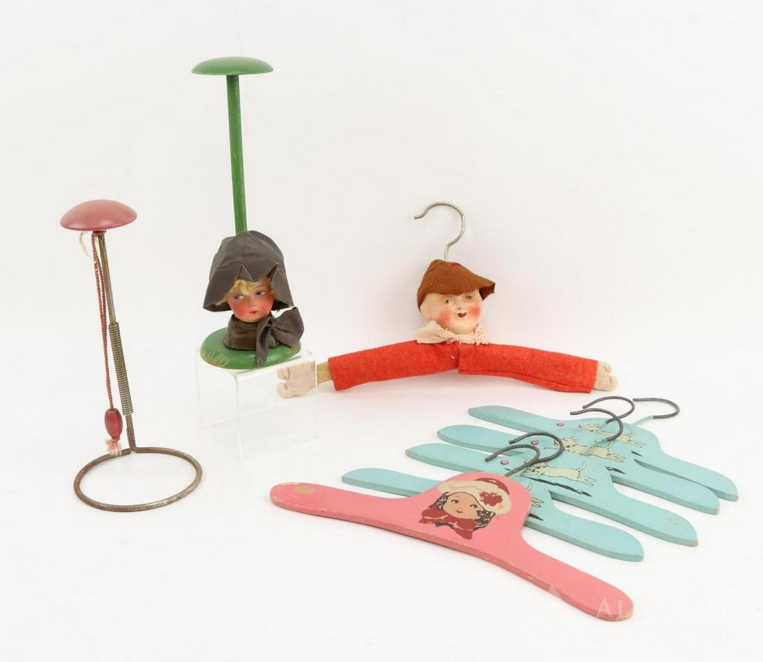 LOT OF HOLIDAY/NOVELTY.: Lot of hat stands and hangers. (2) Hat stands - (1) has a papier mache doll head on base. (1) Is plain. Hangers - (1) has a papier mache doll head on it. (1) Has a picture of a painted doll head. (4) 