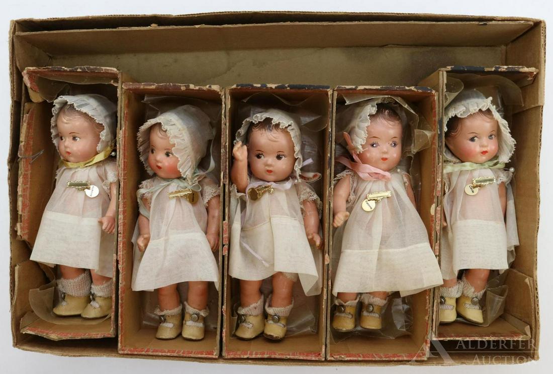 LOT OF DIONNE QUINT DOLLS.: Set of (5) 7" composition Madame Alexander dolls in tagged outfits. They have the 5 pc. toddler bodies, painted brown side glance eyes, painted hair. All of them have their organdy dress and bonnet, i