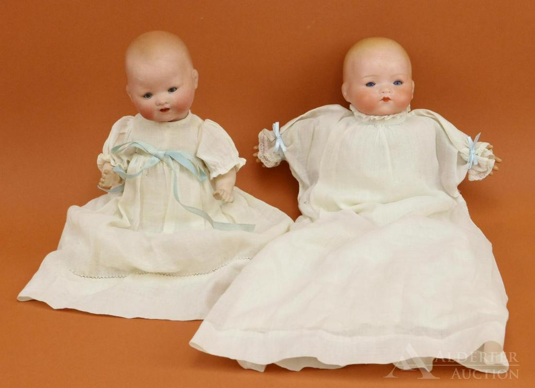 LOT OF GERMAN BISQUE HEAD BABY DOLLS.: Pair of solid dome ARMAND MARSEILLE dolls. Both have blue sleep eyes, painted blonde hair. Dressed in antique white gowns, petticoats. Doll 1) 10" AM GERMANY 351./2/0/X.K . Open mouth. 5 Pc. papier ma