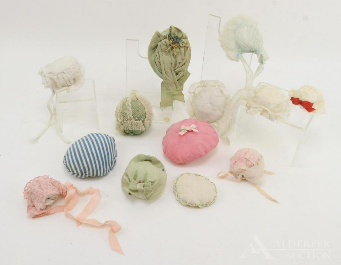 LOT OF ANTIQUE/VINTAGE DOLL HATS.: Lot of (13) hats, bonnets. (6) Vintage - cotton, cotton knit, embroidered organdy, lace. (7) Antique - Decorated French Fashion bonnet, silk satin, cotton tulle, cotton organdy. Condition: this lot is