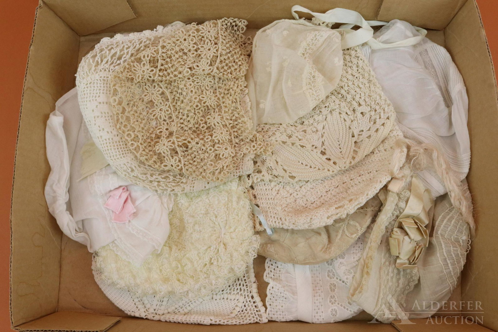 LOT OF ANTIQUE/VINTAGE BABY BONNETS.: Lot of (12) cotton, silk bonnets. Crocheted, tatted, eyelet, ruffled lace, embroidered silk. One is for a tiny newborn. Some, but not all, have ties. Condition: this lot is being sold AS IS.