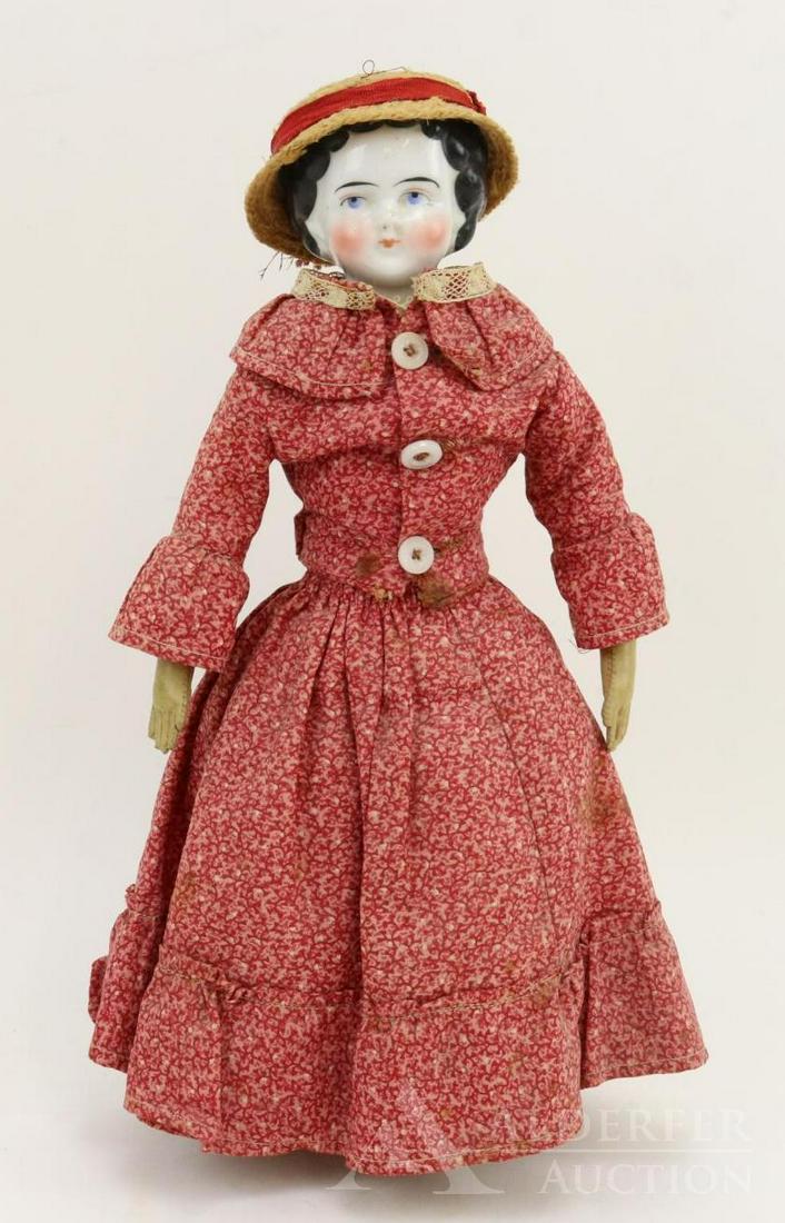 LOT OF CHINA/PARIAN DOLL(s).: 12" 1870's-1880's China shoulder head doll with black center part hair, high brow style. Original cloth body with camel leather lower arms, sewn down fngers. Red leather boots, red/white striped stock