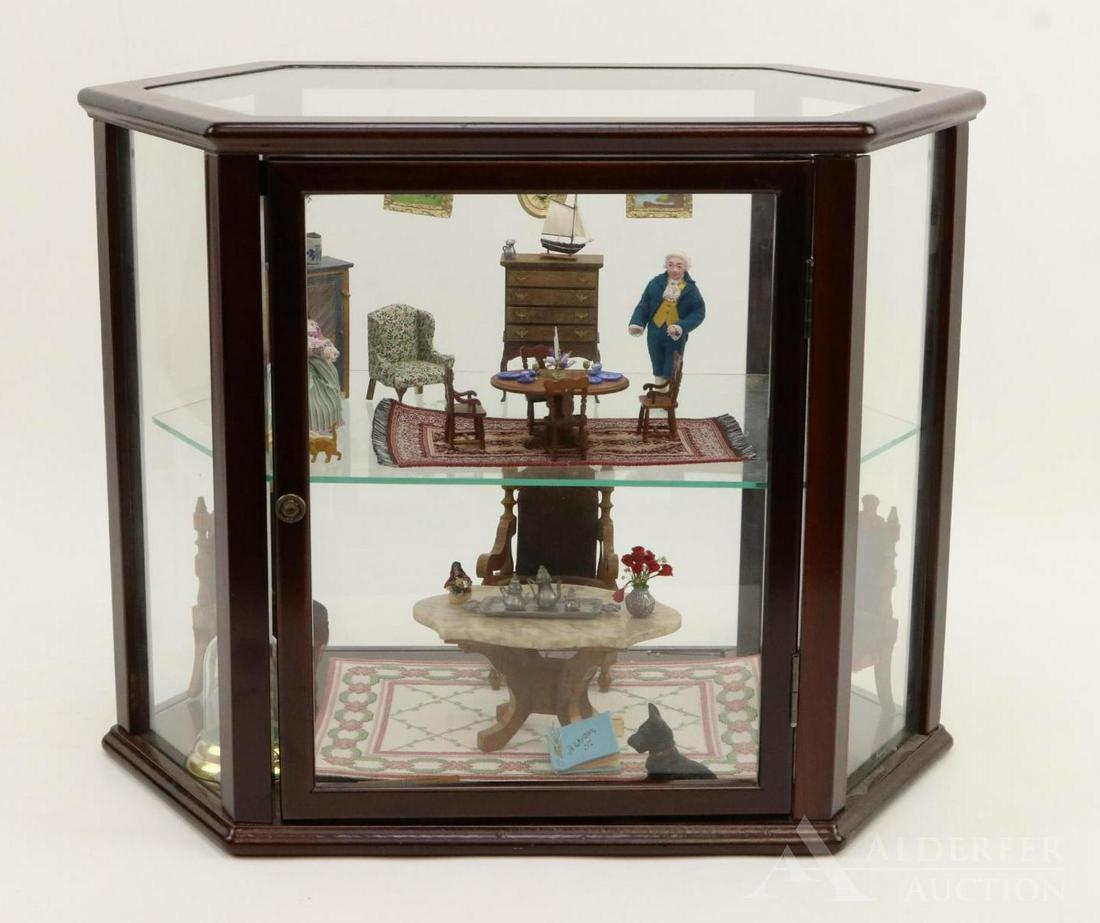 LOT OF MINIATURES IN DISPLAY CASE.: Six-sided display case 12" T x 15 1/2" W x 9 1/2" D. Comes with assembled furniture, accessories and (2) dolls. Some signed. Top shelf - Queen Anne chair - S. Hoelty 1990. Pie safe - 1992. Chest on st