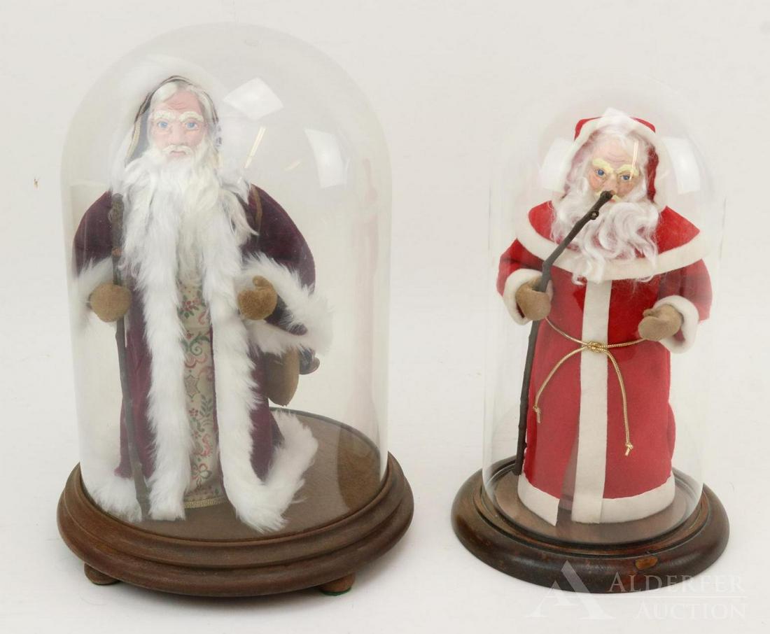 LOT OF HOLIDAY/NOVELTY.: Pair of Santas in glass domes made by artist Regina Steele. 10" Santa with sack of toys. Sculpted face. Included with toys is a Carl Horn doll. Glass dome is 11 1/2" T x 7" W. 9 1/2" Santa with sculpt
