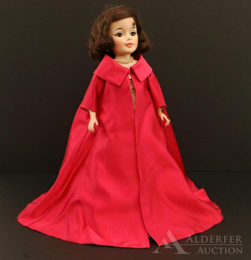 DOLLS OF THE 1950's-1960's.: 21" Madame Alexander "Jacqueline". 1961 Doll dressed in all original tagged evening clothes - long red satin coat over ivory brocade gown. Silver heels, pearl purse, pearl necklace and earrings, diamo