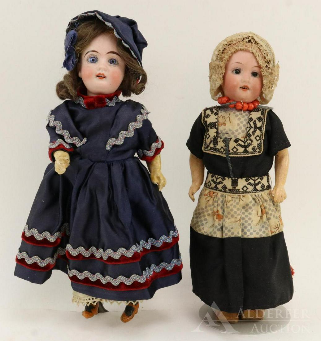 GERMAN BISQUE HEAD DOLLS 12" AND UNDER.: Pair of 9" dolls. Both diolls have open mouths, brown mohair wigs, 5 pc. papier mache bodies. Doll 1) GbrK (in sun symbol) 44.-18. Stationary blue eyes. Molded tan shoes. Dressed in contemporary cloth