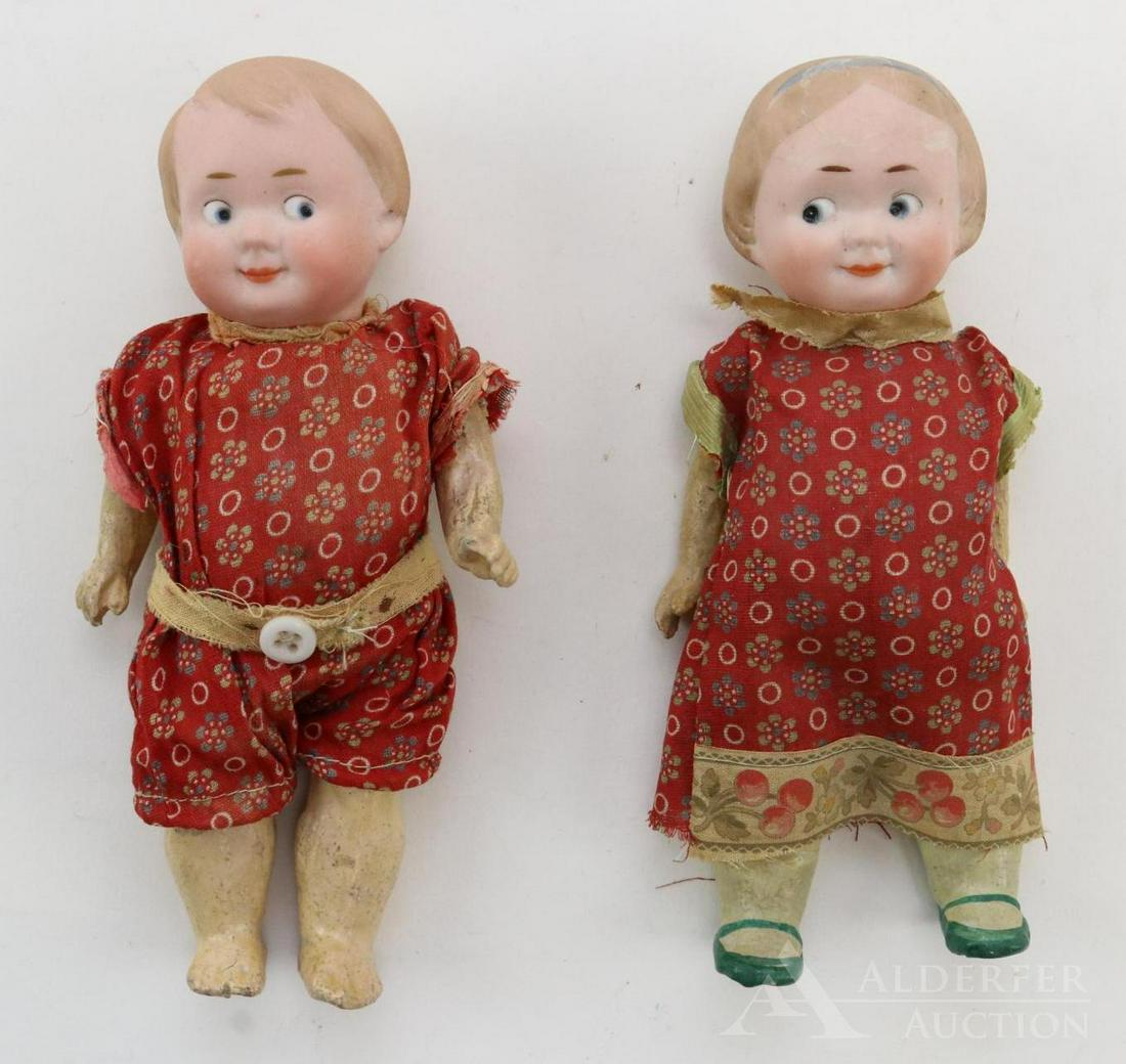 GERMAN BISQUE HEAD DOLLS 12" AND UNDER.: Pair of GOOGLY eye character dolls. Both dolls (boy and girl) are marked R45A and R46A, 11/0. They have solid domes with painted features. Blue side glance integlio eyes, watermelon type smiles, blond