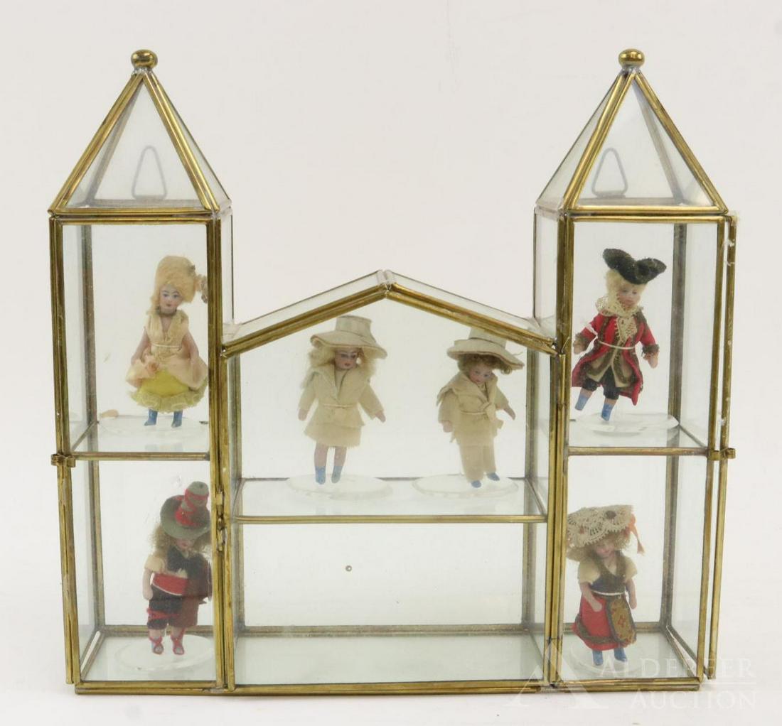 LOT OF ALL BISQUE FRENCH/TYPE DOLLS.: This is an original family owned lot. Set of (6) all original 2 1/2" "Les Lilliputiens", 1912, with blue boots. Each comes with a stand. This set comes in a glass showcase with a "room" for each indiv