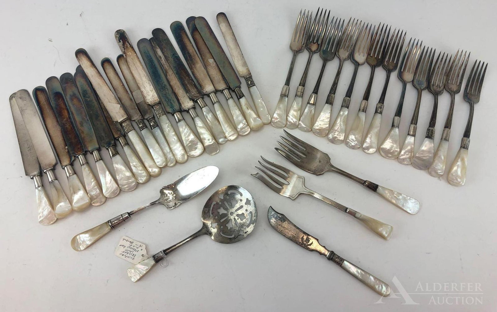 Mother of Pearl with Sterling band Flatware: Grouping includes 12 forks,18 knives and 5 serving pieces. The grouping includes 2 handle styles and one set of handles were paired with existing flatwares of different styles, giving a varied theme t