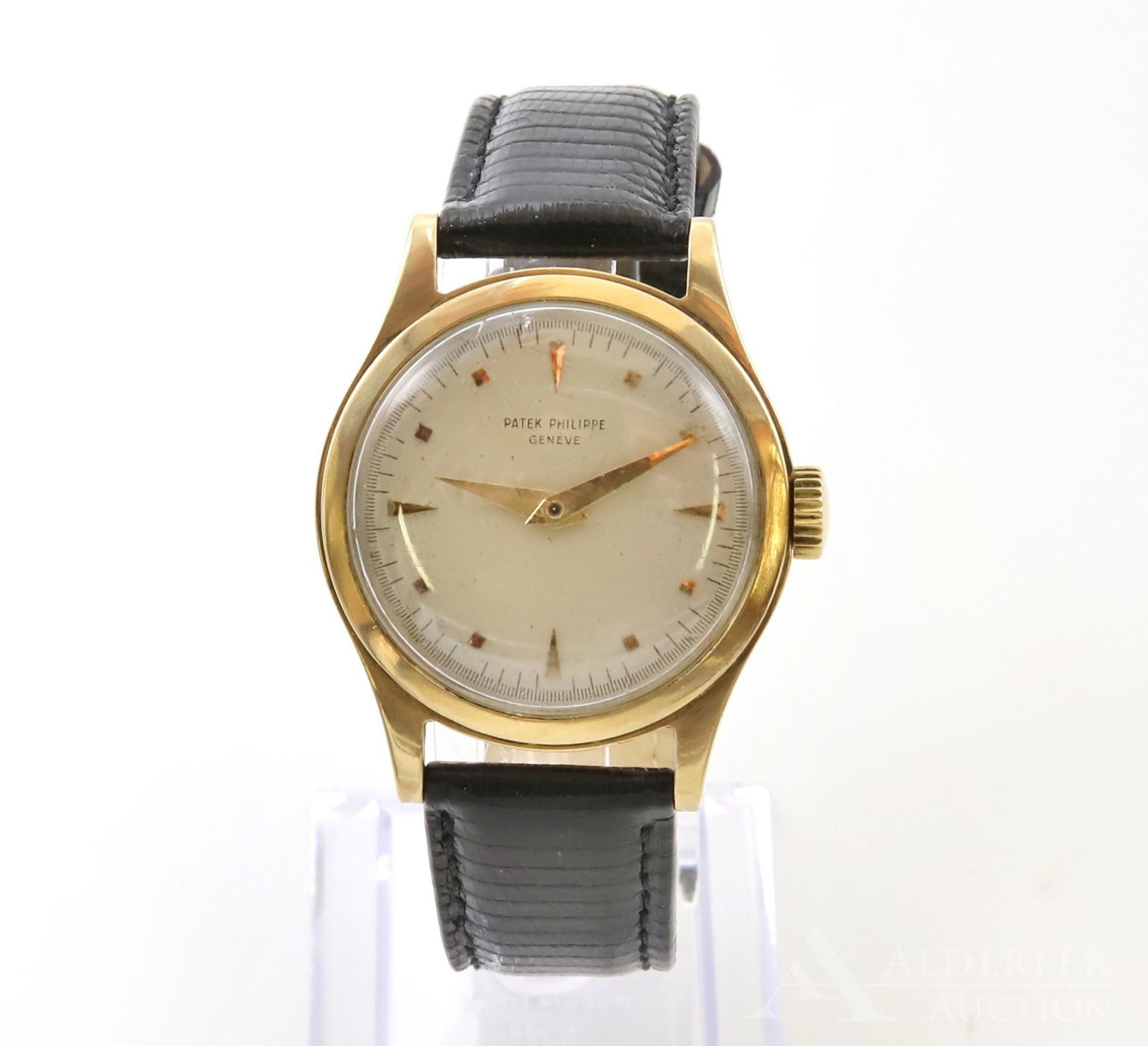 Patek Philippe 18KY Gold Gents Wrist Watch: Patek Philippe Geneve calatrava features a cream face with gold hour markers and hands. 34.8mm round case. New black 18R genuine lizard band handmade in Italy. Running sporadically but not tested or