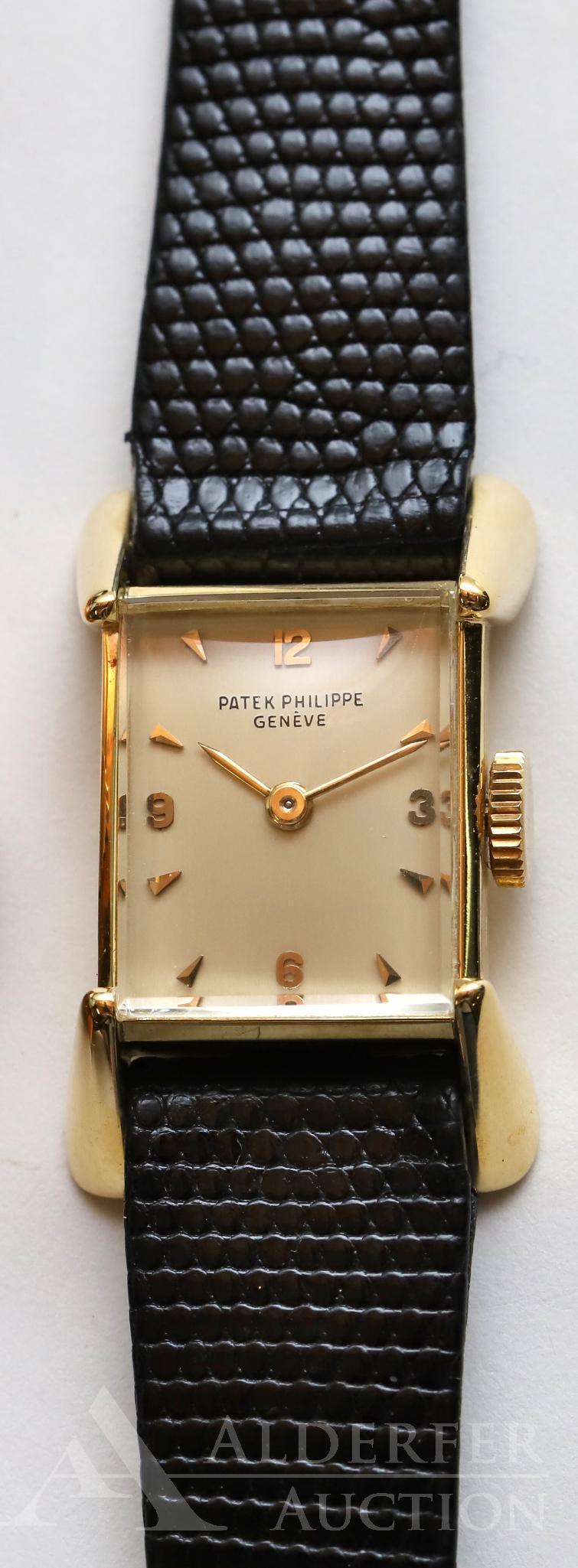 Patek Philippe 18KY Gold Ladies: Patek Philippe & Co. Geneve. Features a cream face with gold hour markers, numbers and hands.18 jewels, serial no. 946818. Adjusted to hot, cold isochronis, 5 pos. Case: 2279 6824675 is 18.5 x 15