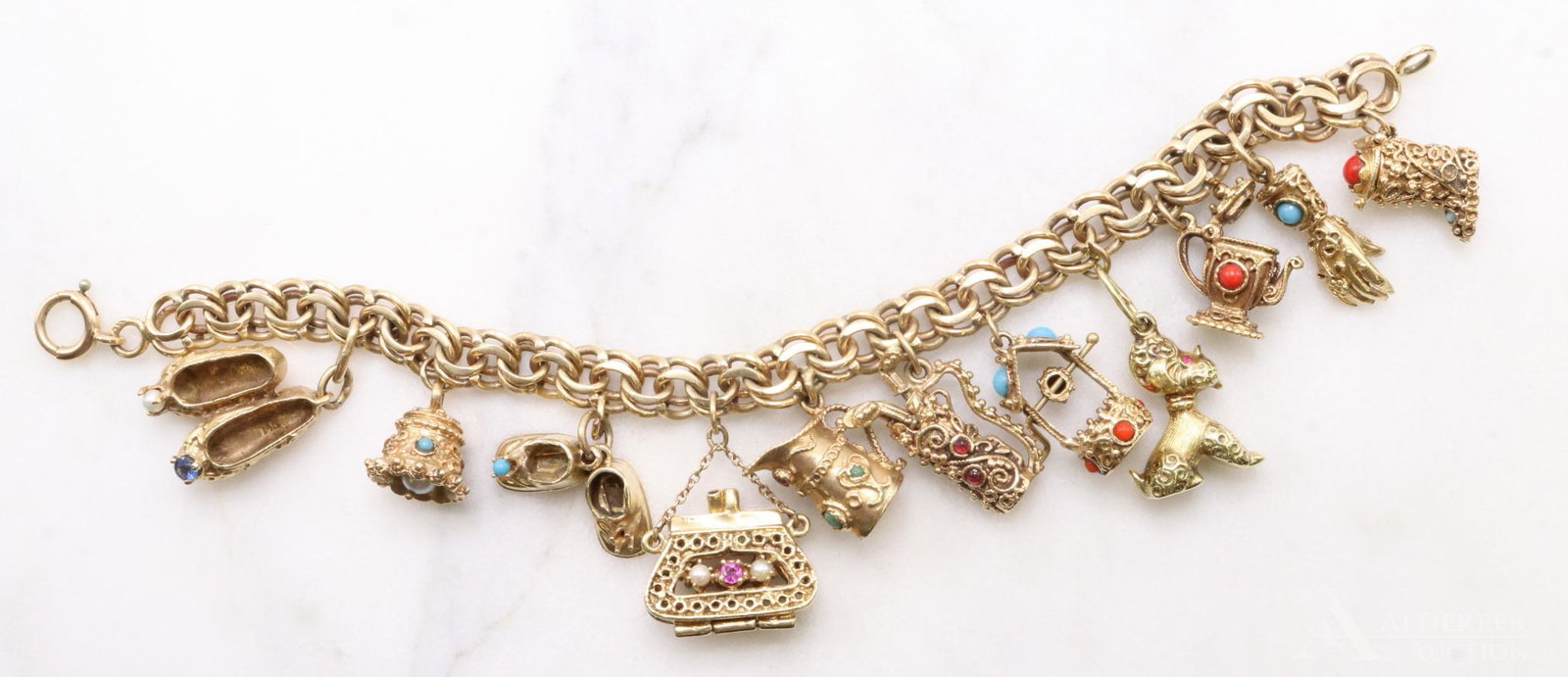 14KY Gold Charm Bracelet with Charms: Bracelet features (11) charms including wirework, sapphire, ruby, pearl, coral, turquoise, boot, hand, coffee pot, dog, wishing well, golf clubs, pitcher, purse, booties (missing a stone), bell, balle