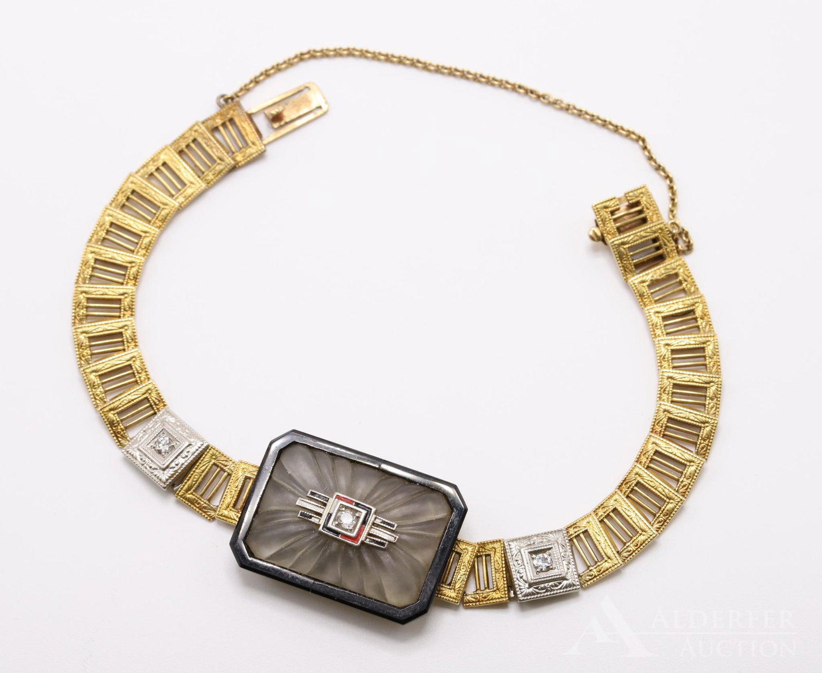 14K Gold Camphor Glass and Diamond Bracelet: Deco design features camphor glass set in a black onyx base. (1) round diamond accents the black and red enameled embellishment (missing some enamel) in the center of the glass, and (2) round diamonds