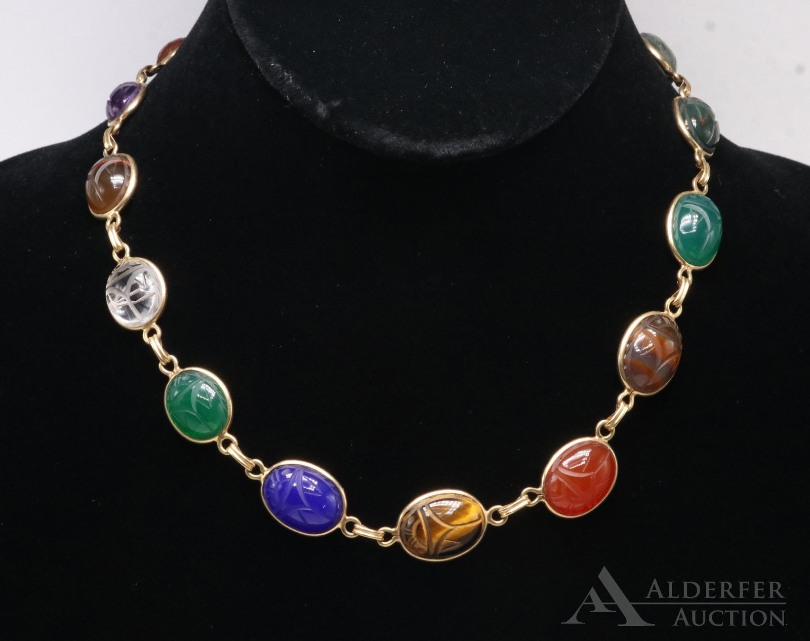 14KY Gold Stone Scarab Necklace: Graduated carved stone scarabs. Including carnelian, amethyst, agate, clear quartz, green onyx, blue chalcedony, tiger eye, blood stone, moss agate, black onyx. 16" long. 29.5gtw