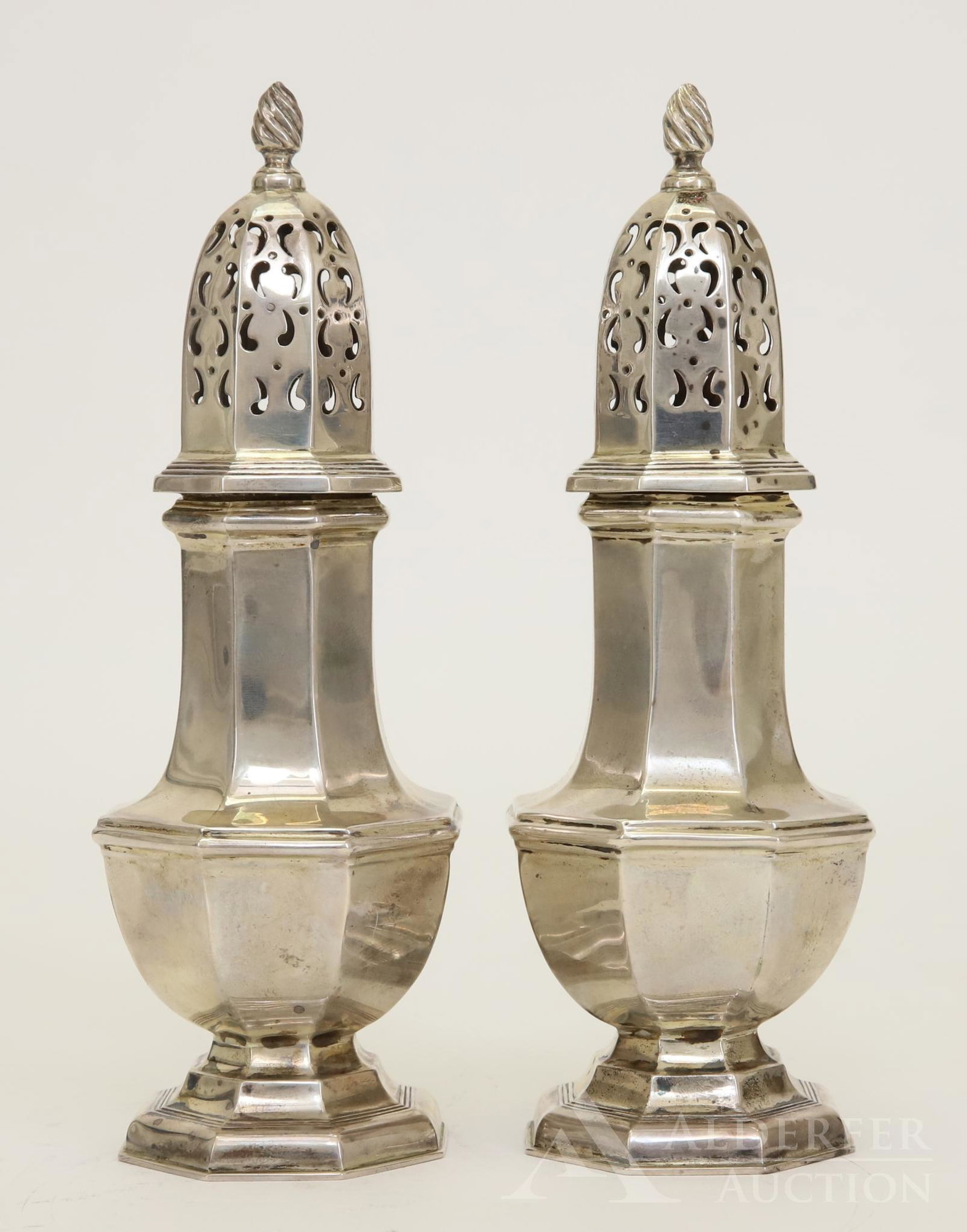 19th c. English Sterling Silver Muffineers: A pair of English sterling silver muffineers, or sugar casters, in cobalt blue velvet lined case. Classic design with flame finial. Dated 1899, unknown maker, London. 6.75" and 8.0ozt