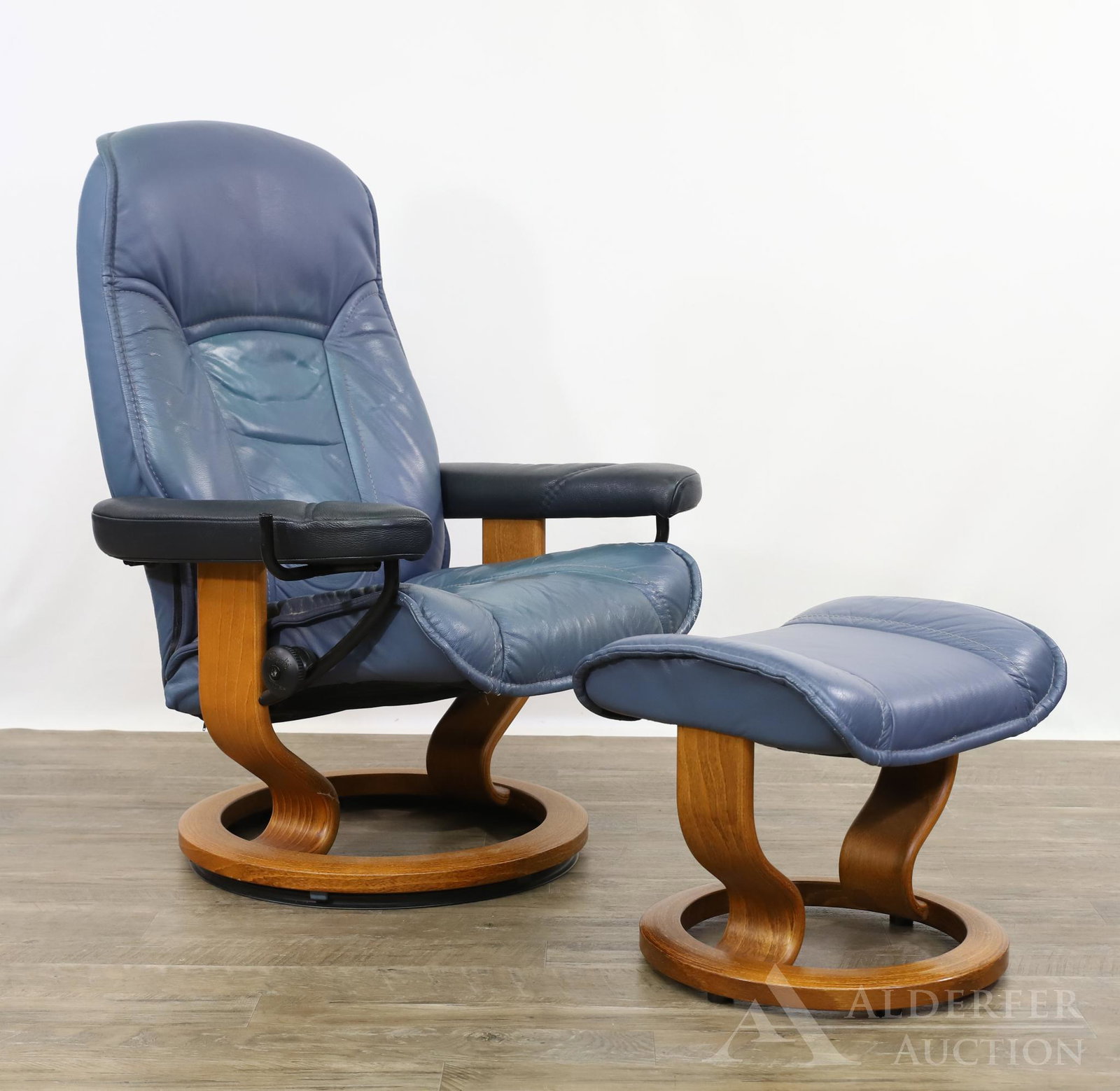 Erkornes Norwegian Stressless Consul Chair and Ottoman: Reclining chair with bluish gray leather seat and back with a teak frame. Chair: 40.5h" x 31w" x 26d" Ottoman: 14.5h" x 19w" x 19d"