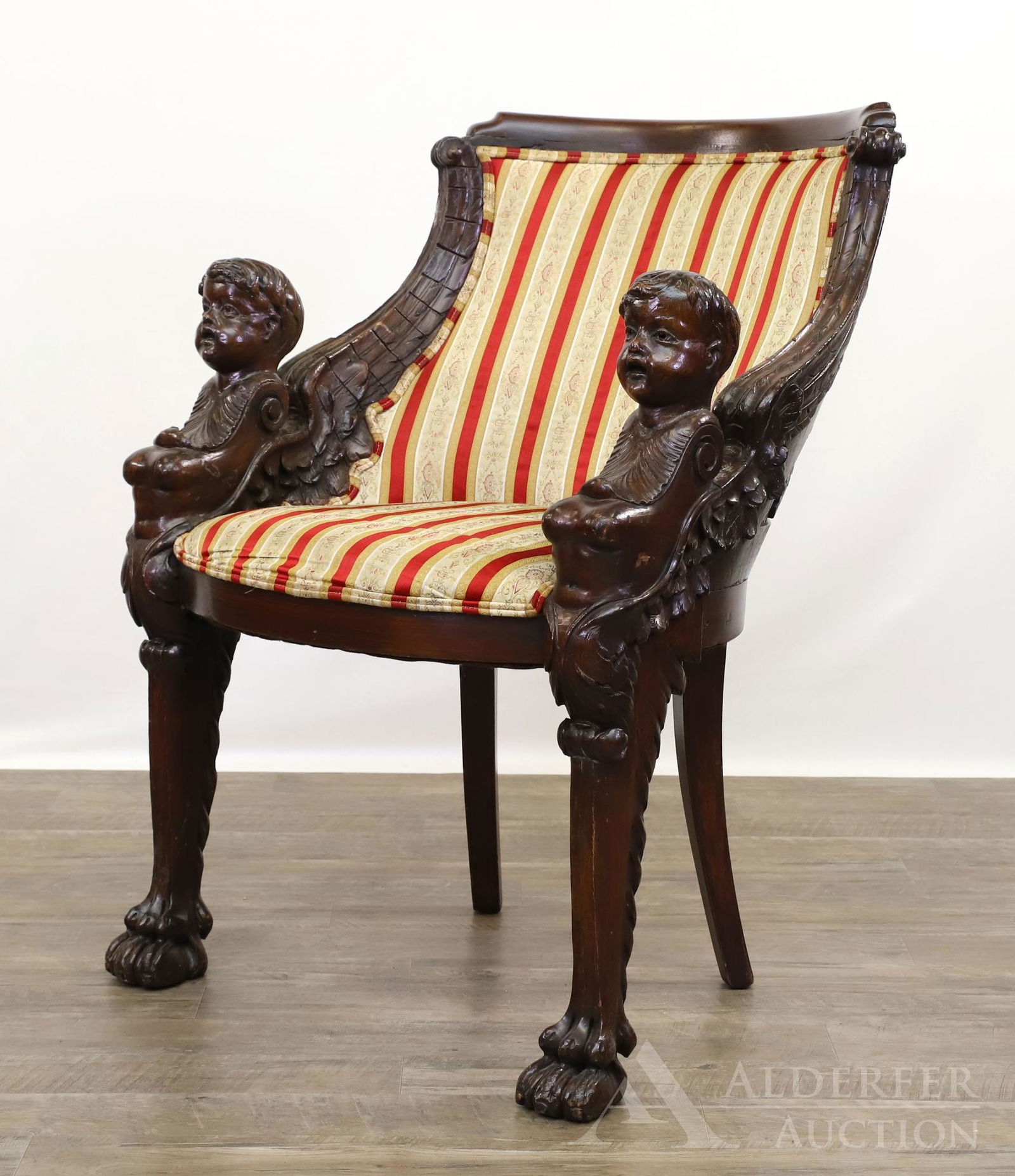Putti and Griffin Carved Mahogany Arm Chair: Ornate chair with winged putti arms on paw feet with the back of the chair having a center gargoyle motif flanked by two griffins. 36h" x 26w" x 27d"