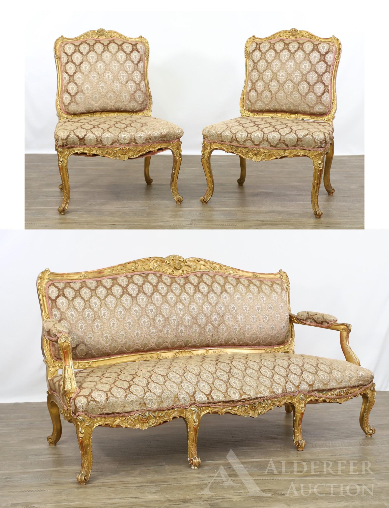 French Parcel Gilt Carved Parlor Suite: (3) piece suite with gilt carved c-scroll, acanthus, and floral decoration, on scrolled cabriole legs. Suite includes (1) settee with six legs and (2) side chairs Chairs: 39h" x 25w" x 26d" Sofa: 3