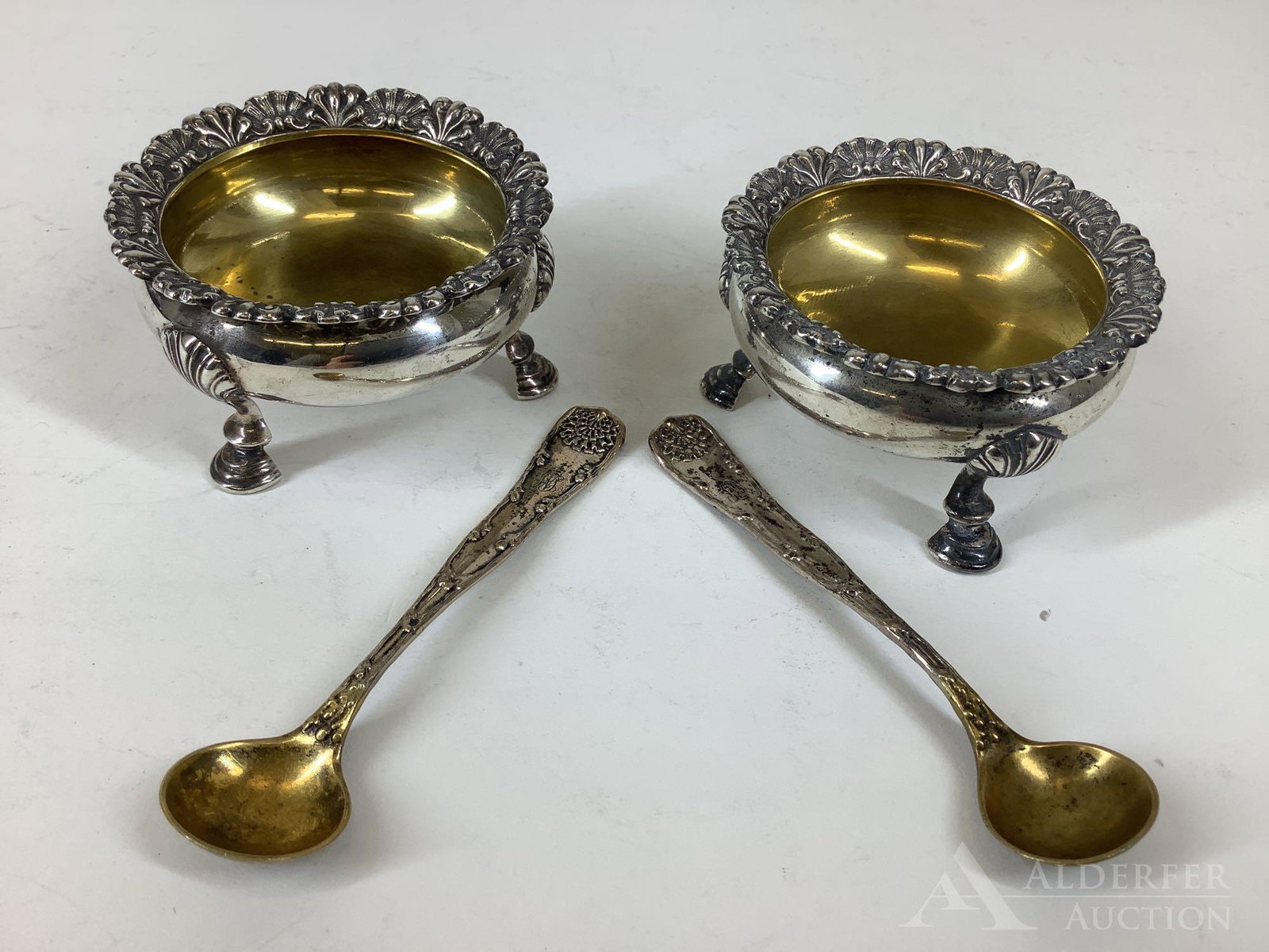 Tiffany & Co. Sterling Silver Salts: Pair of Tiffany & Co. sterling silver salt cellars with gold washed interiors and hoof feet, includes complementing gold washed Tiffany spoons. Dated 1892-1902. Monogrammed. 1.5"h x 2.5"round 4.2oz