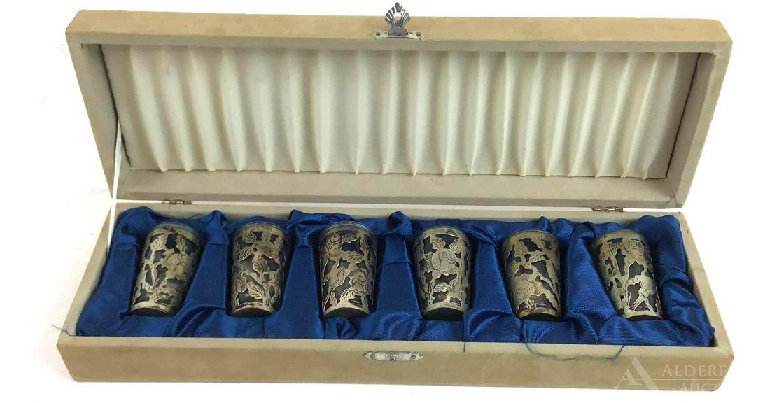 Cased Sterling Silver Cordials or Shot Glasses: Cased set of (6) sterling silver cordials with glass inserts and hand chased floral decoration. 2"h