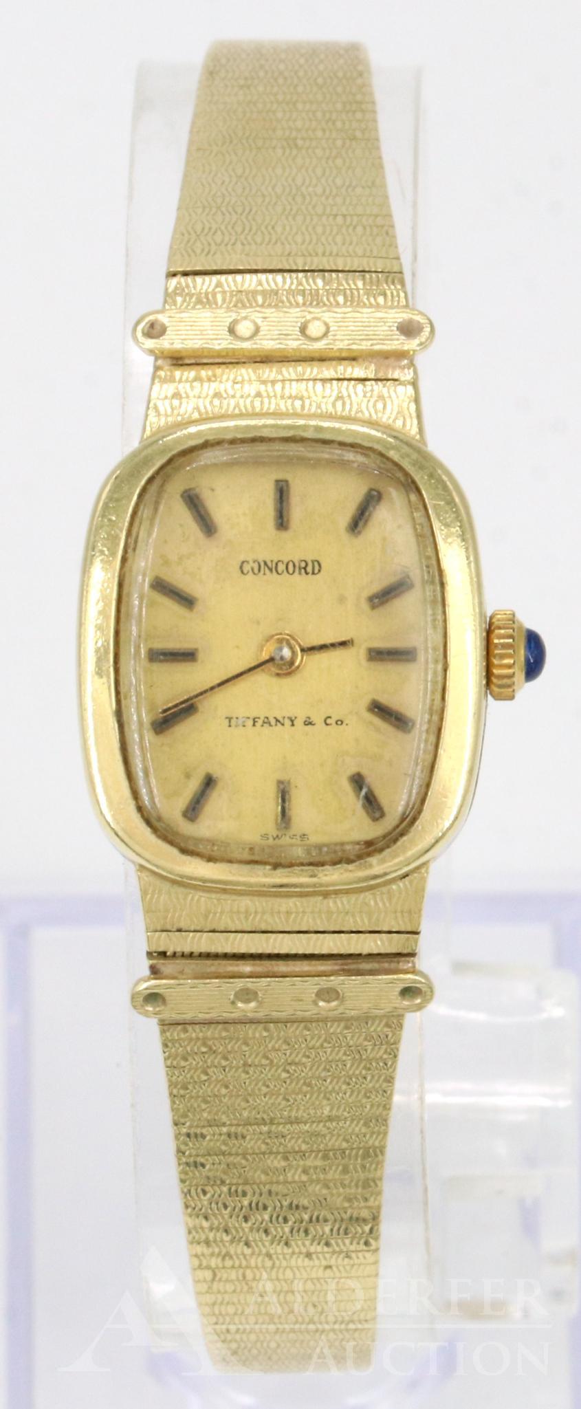 Tiffany & Co. 14KY Gold Concord Wrist Watch: Dial reads Concord Tiffany & Co. Thailand movement, Swiss parts, 1 jewel, V321 battery. 20.5 x 17.7mm bezel. 6.5" long with a sleek textured bracelet, marked "c" on clasp . Currently not running, may