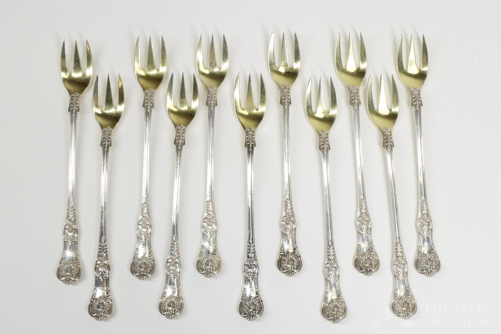 Tiffany & Co. Sterling Silver Oyster Forks: Grouping of 11 "English King" Tiffany & Co. sterling silver oyster forks with gold washed bowls. 6" and 9.5 ozt