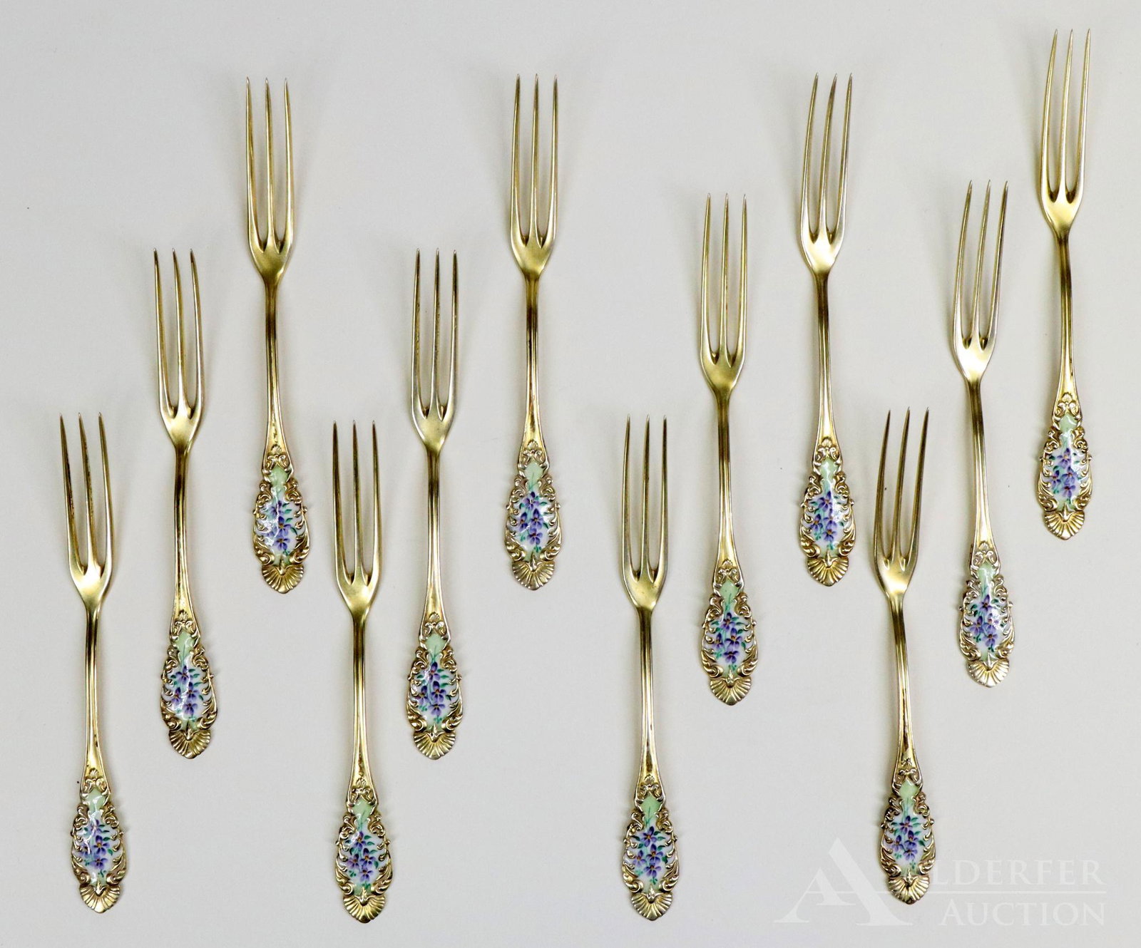 Sterling Silver and Enamel Strawberry Forks: Collection of 12 R. Blackinton & Co. sterling silver strawberry forks with gold wash and floral decorted enamel handles. 4" and 3.3 ozt