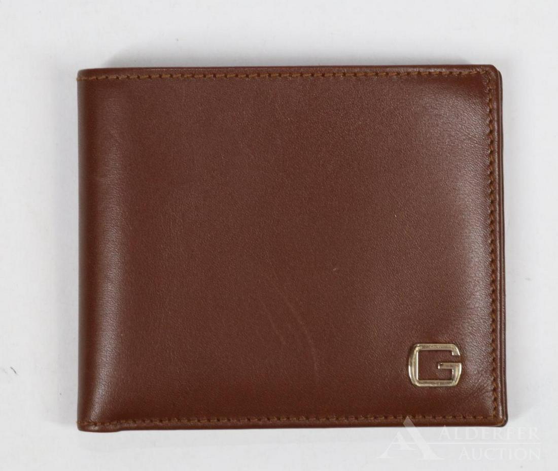 Gucci Leather Wallet: Brown leather man's wallet with double bill compartment and credit card slots (6). Includes box. 3.5"h x 4.25"w and 8.25"w opened