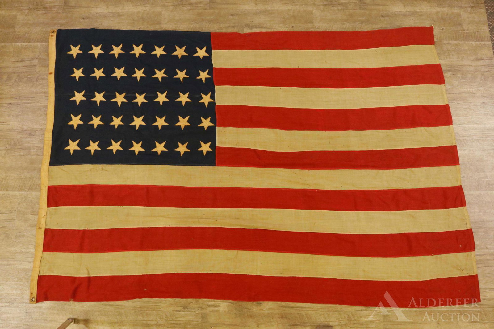 Historic 35-Star United States Flag: United States 35-star flag (7-7-7-7-7 configuration) of linsey-woolsey construction and machine sewn. Flag measures 64" x 90" and presents brass grommets on pole edge. Flag exhibits some mothing. The 