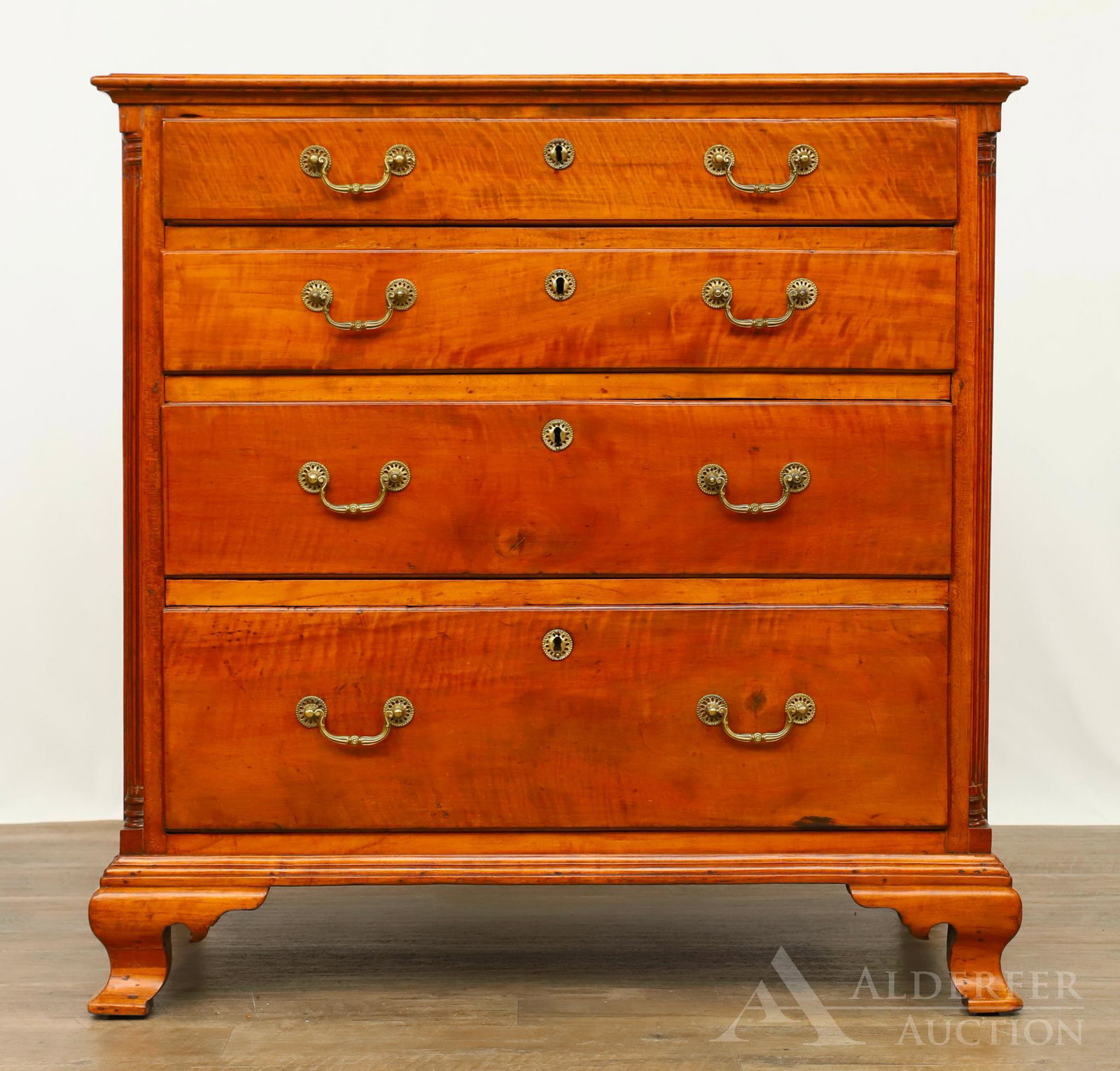 Chippendale Chest of Drawers: Tiger maple case, four graduated drawers flanked by quarter columns on ogee bracket feet. 37"h x 37.5"w x 20" d