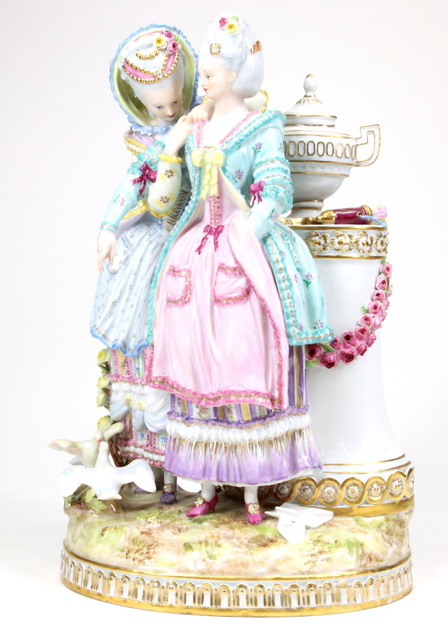 Meissen Figure: Meissen Figurine of two women near pedestal, with letter and doves. Blue crossed swords mark. 10"h x 6.5"w x 5"d
