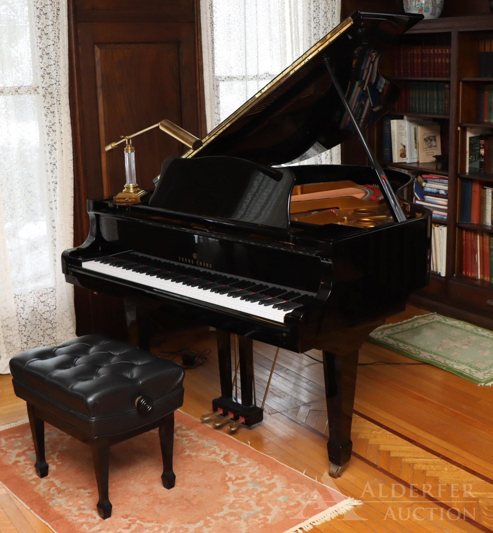 Young Chang Parlor Grand Piano: 6'1" Young Chang grand piano, Model 185. Made in Korea and purchased locally in Allentown the 1990's. Black polished ebony case with adjustable leather seat. Piano was routinely tuned throughout its l