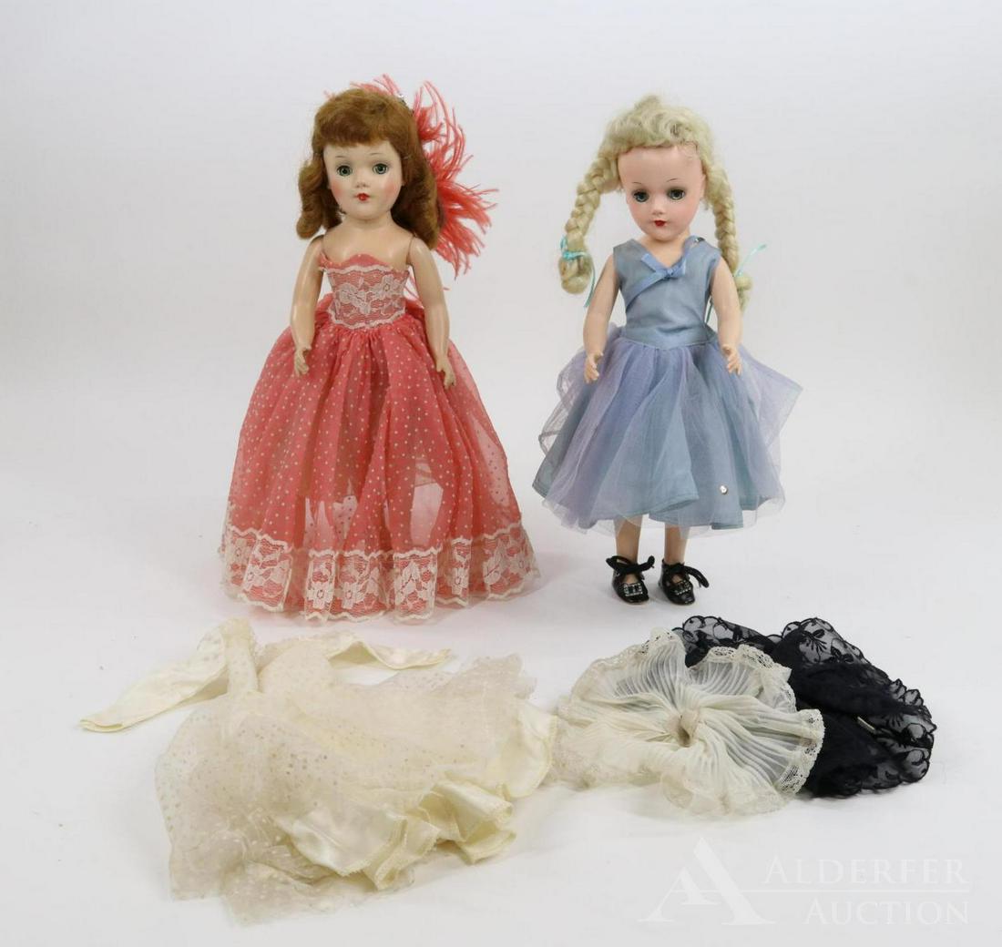 DOLLS OF THE 1950's-60's.: Pair of MARY HOYER dolls. Both dolls have blue eyes. Platinum blonde - tagged blue gown, NO panties. Black oilcloth shoes. Redhead - tagged coral dotted Swiss gown, (feathers in hair), tagged petticoa