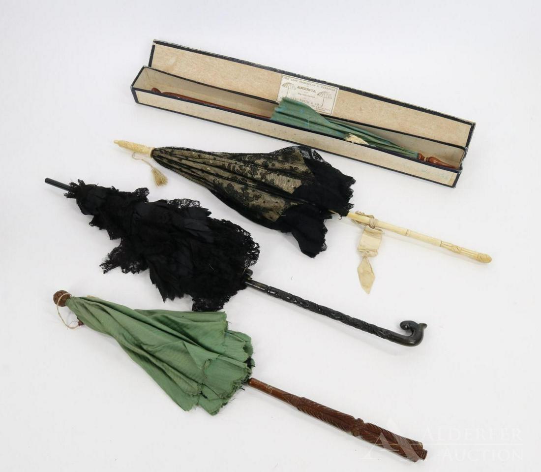 LOT OF ANTIQUE ACCESSORIES.: Lot of (4) antique ladies parasols. All of them have carving on their handles. 23 1/2" Black lace over white silk, bone handle. 23 1/2" Black silk taffeta, cotton and lace that folds. 20 1/2" Green co