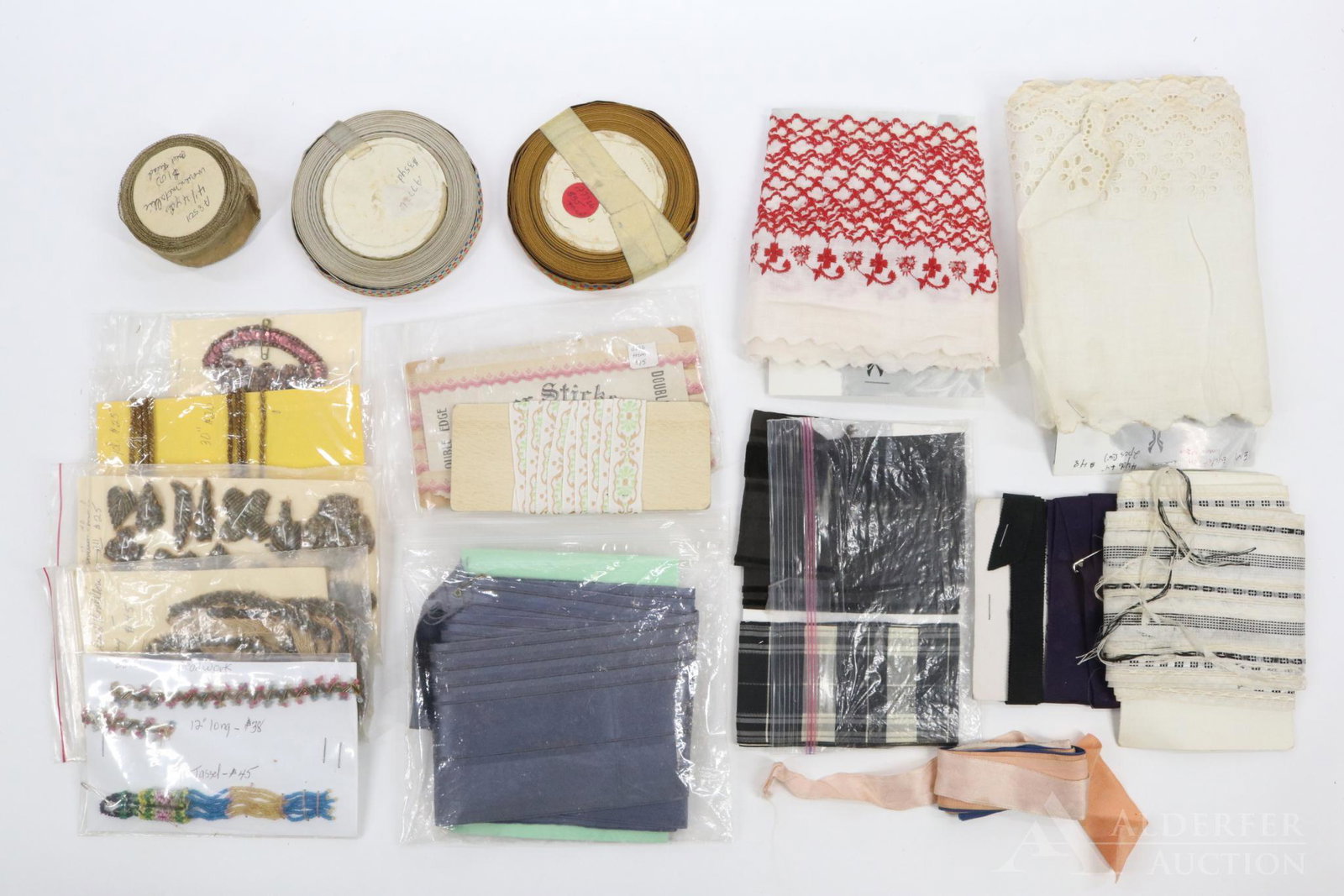 LOT OF ANTIQUE SEWING ITEMS.: Lot of trims, ribbons, lace. (Yardage is not known on any of the items.) 7" W. eyelet. 2 1/2" W. red embroidered edging. 3 Yds. Double Edge trim. 4 Pkgs. applique, bouillon trims, rolled gold. Beadwor